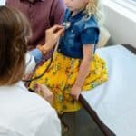 Photo: A doctor reviews a child in an office in a file photo without date.