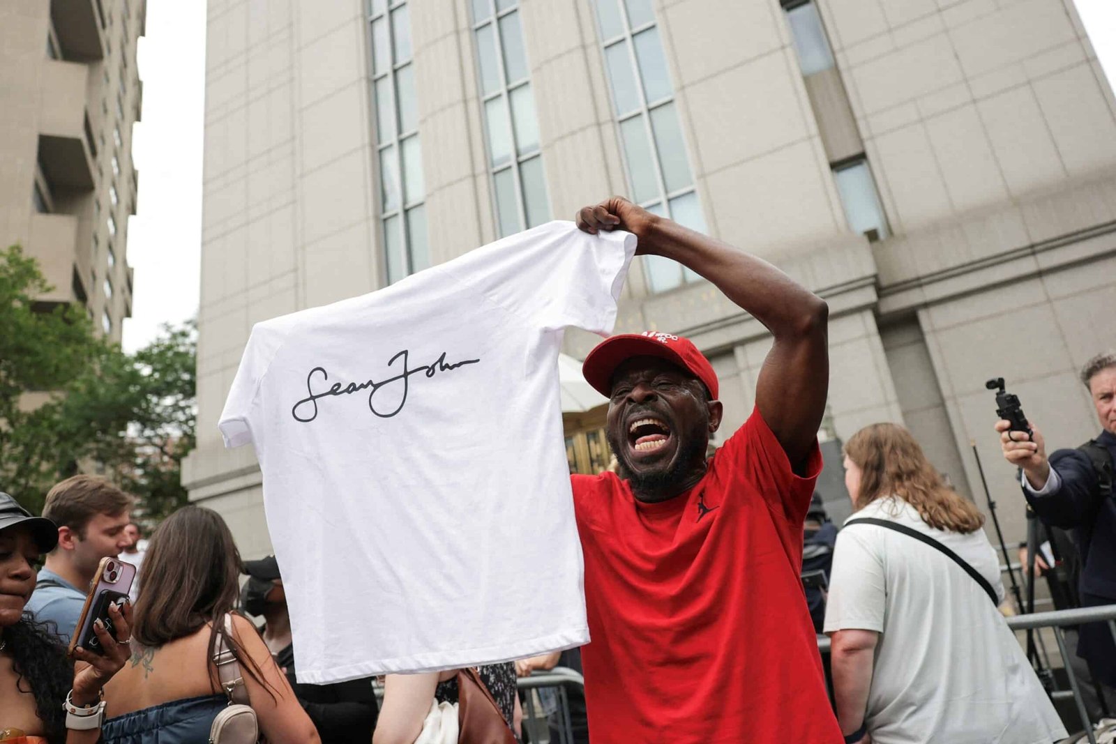 Photo: A man holding Sean John reacts outside the Federal Court of the United States, after the jury reached verdicts in Sean "Diddy" Pastor of conspiracy of sex trafficking of combs and extortion, in New York City, July 2, 2025.