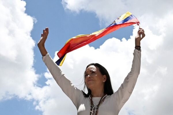 PHOTO: Venezuelan opposition leader María Corina Machado waves a Venezuelan flag during a demonstration in Caracas on August 28, 2024.