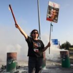 PHOTO: A woman holds a sign with a photograph of Israeli hostage Dror Or on April 19, 2024, during a protest calling for his release.