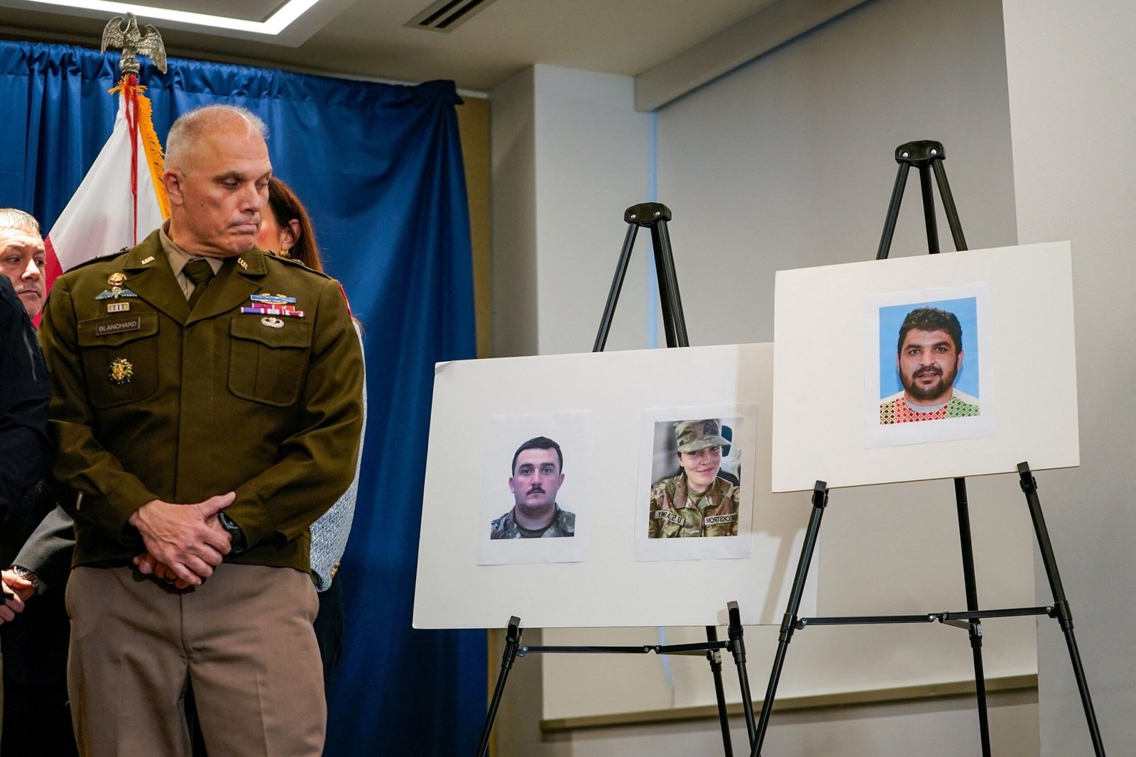 PHOTO: Brigadier General Leland D. Blanchard II looks at photos of two National Guard members who were shot along with a photo of a suspect, Afghan national Rahmanullah Lakanwal, at a news conference in Washington, DC, Nov. 27, 2025.
